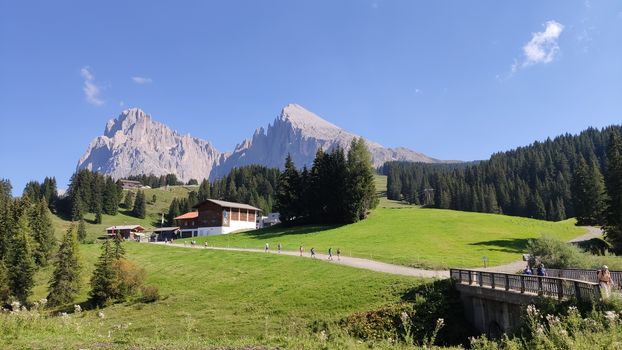 Val Gardena, Italy - 09/15/2020: Scenic alpine place with magical Dolomites mountains in background, amazing clouds and blue sky in Trentino Alto Adige region, Italy, Europe