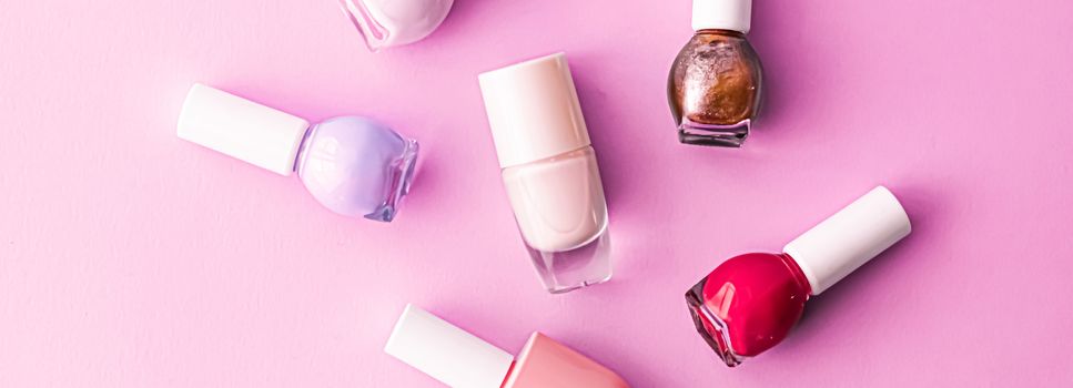 Nail polish bottles on pink background, beauty branding