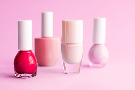 Nail polish bottles on pink background, beauty branding