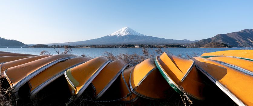 View of Mt. Fuji or Fuji-san with yellow boat and clear sky at lake kawaguchiko, Japan.