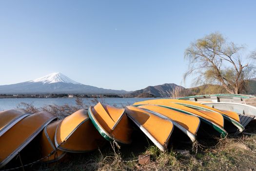 View of Mt. Fuji or Fuji-san with yellow boat and clear sky at lake kawaguchiko, Japan.
