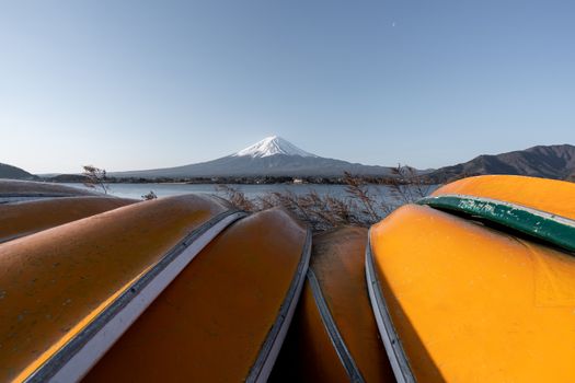 View of Mt. Fuji or Fuji-san with yellow boat and clear sky at lake kawaguchiko, Japan.
