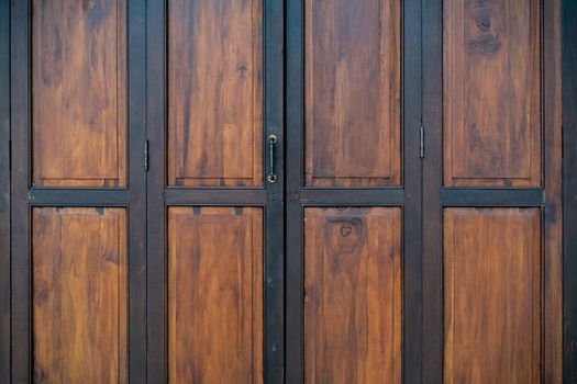 ฺBlack and brown old wooden folding doors.