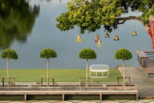 chair near river and green view.