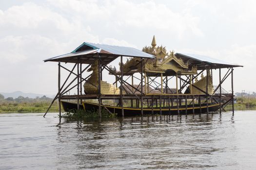 Inle Lake Myanmar 12/16/2015 with ceremonial boat under cover. Home to the Intha, Shan and other peoples. Known as the Floating Gardens as the town is rich with vegetable growingHigh quality photo