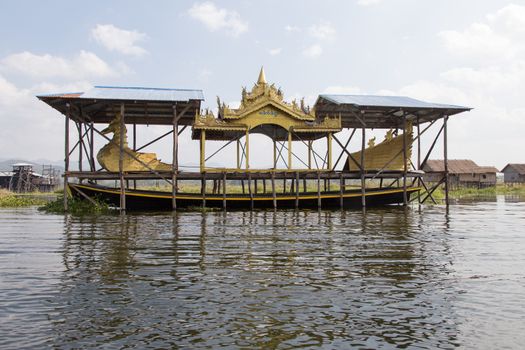 Inle Lake Myanmar 12/16/2015 with ceremonial boat under cover. Home to the Intha, Shan and other peoples. Known as the Floating Gardens as the town is rich with vegetable growingHigh quality photo