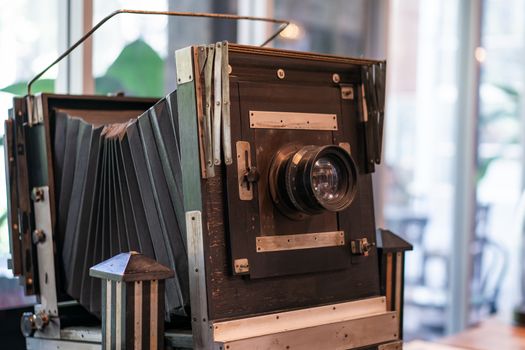 Vintage, antique large format camera in blurred background.