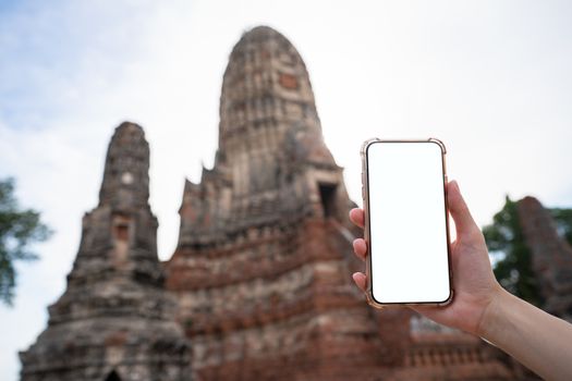 Mockup image of hand holding mobile phone with blank white screen with Pagoda.