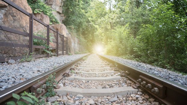 Vintage railroad, railway tracks in a rural scene with golden light at the end destination.