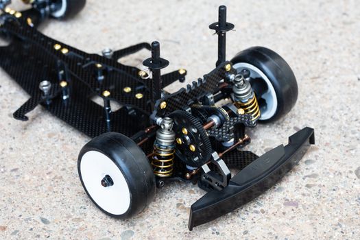RC car chassis and parts being built to form a radio controlled race car.