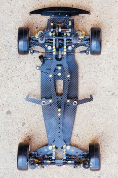 RC car chassis and parts being built to form a radio controlled race car.