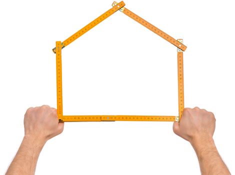 Male Hand with yellow wooden meter. Human Hand holding tool forming a house, Isolated on White Background.