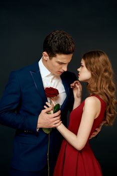 Beautiful couple charm hug lifestyle relationship rose luxury dark background. High quality photo