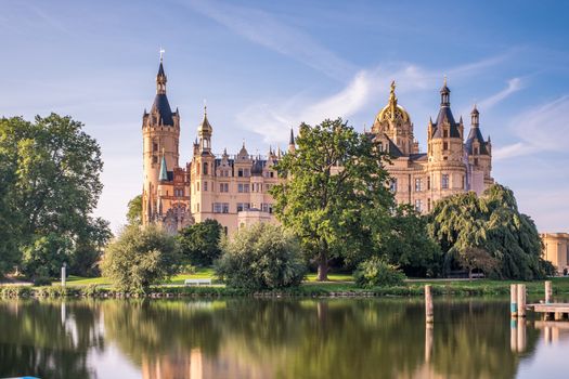 Beautiful fairytale castle in Schwerin, view from the pier.