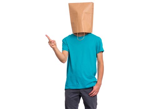 Portrait of teen boy with paper bag over head pointing hands away at copyspace, isolated on white background. Child pointing finger at something.