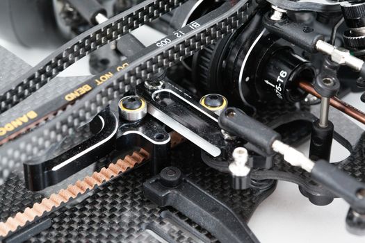 RC car chassis and parts being built to form a radio controlled race car.