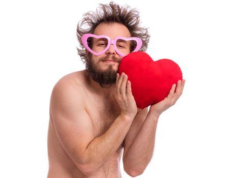 Happy Valentines Day. Crazy bearded Man with funny Haircut in eye Glasses. Happy and silly guy in Love, isolated on white background. Cheerful naked man with Red plush Heart.