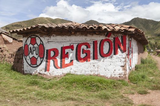 Ccorao, Peru - April 4, 2014: APU political propaganda graffiti on the road to Taray and Pisac, Peru.