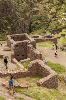 Pisac, Peru - April 4, 2014: Archaeological Park of Pisac, visitors and tourists in the ruins of the ancient Inca city, near the Vilcanota river valley, Peru.