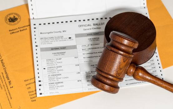 Concept for problems in deciding Presidential election in the USA with judge's gavel on absentee ballot