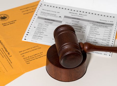 Concept for problems in deciding Presidential election in the USA with judge's gavel on absentee ballot