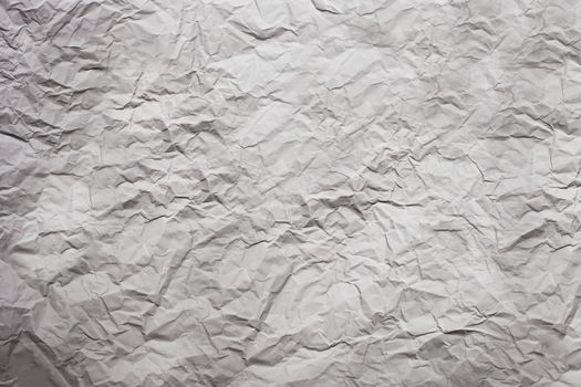 Strongly rumpled paper of gray color.Texture.Background