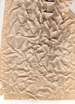 Heavily crumpled yellow paper with ragged ends