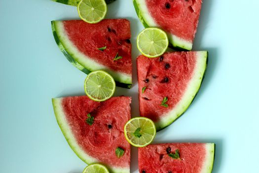Juicy watermelon slices with lime wedges.Texture or background