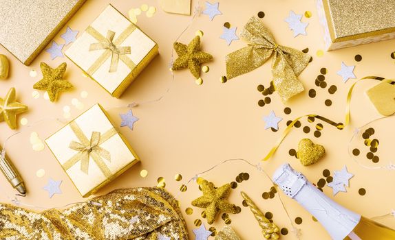 New Year and Christmas flat lay. Birthday party background. Top view of golden party decorations with confetti and gift boxes flat lay