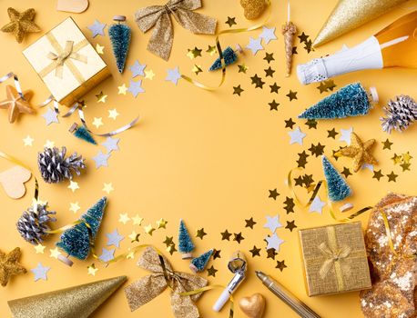 New Year and Christmas flat lay. Top view of golden christmas and new year decorations with confetti and gift boxes flat lay