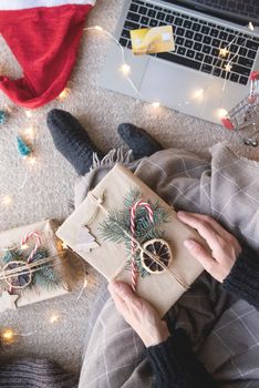 Christmas planing, online shopping concept. Top view of woman shopping online at christmas holidays holding the gift box