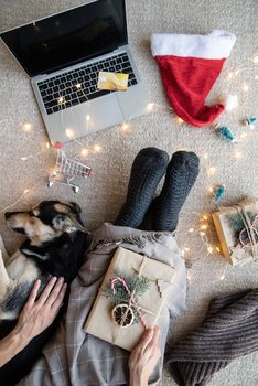 Christmas planing, online shopping concept. Top view of woman shopping online at christmas holidays holding the laptop and credit card