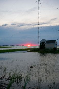 A Red Sunset Next to a Large Metal Radio Tower at the Bay in Wildwood New Jersey