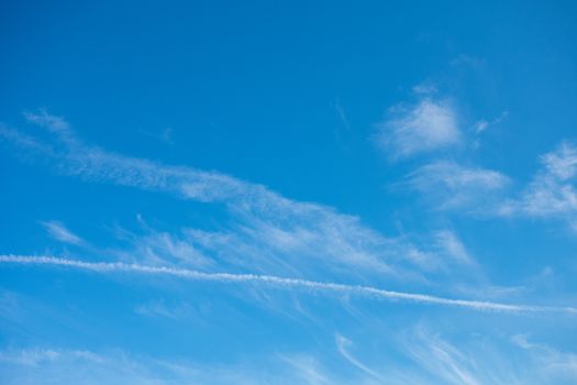 A Gorgeous Clear Blue Sky With Clouds and Contrails for Sky Replacement