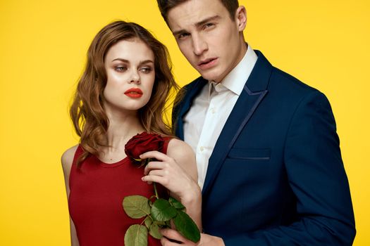 Couple in love man and woman with red rose classic costume red dress model. High quality photo
