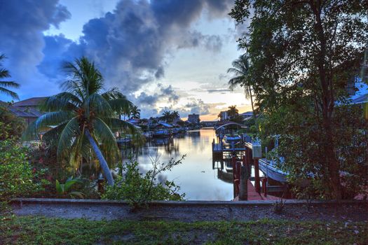 Boat lift in a waterway at sunset in Naples, Florida