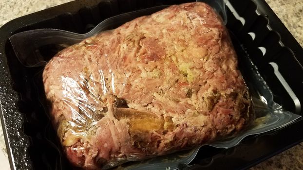 savory red meat pork in plastic bag in container