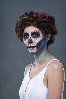 Closeup portrait of a woman with a sugar skull makeup. Halloween concept