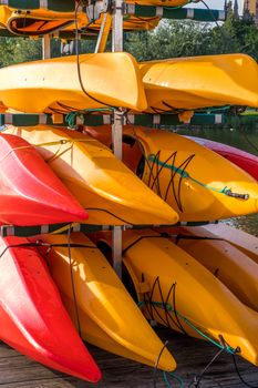 Colorful kayaks on the lake outdoor on a summer day.