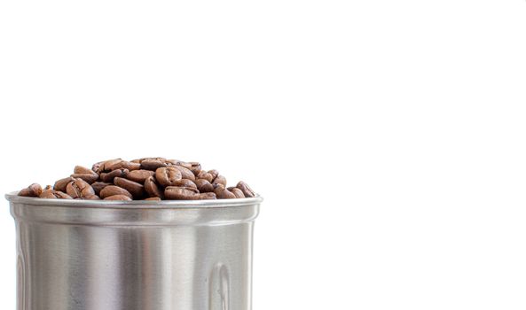 A lot of coffee beans in a metal coffee grinder on a white background. Isolated coffee items