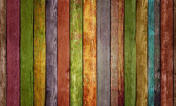 A wooden painted wall consisting of multicolored slats.Texture or background