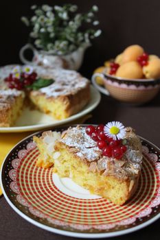 Apple pie sprinkled with powdered sugar and decorated with red currants