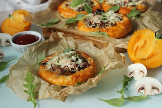 Delicious pastries with mushrooms and meat and decorated with cheese and herbs close-up.Texture or background