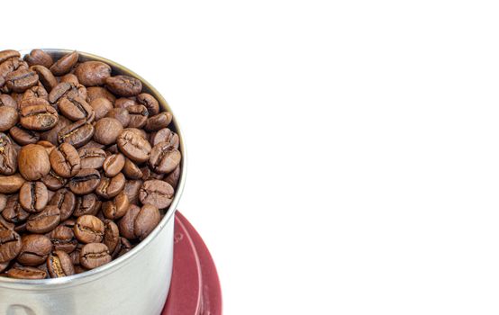 A lot of coffee beans in a metal coffee grinder on a white background. Isolated coffee items