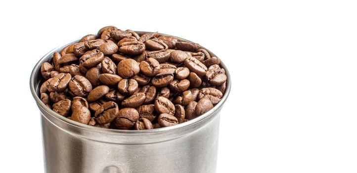 A lot of coffee beans in a metal coffee grinder on a white background. Isolated coffee items