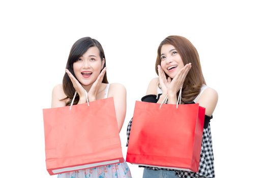 Two beautiful smiling asian young women with shopping sale bags isolated on white background.
