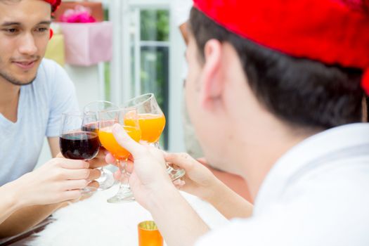 Asian group people drinking at party outdoor. group of friends cocktails in hand with glasses.close up on hand holding beverage.