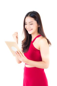 Smiling asian woman in red dress using tablet with glad, girl looking and holding tablet isolated on white background