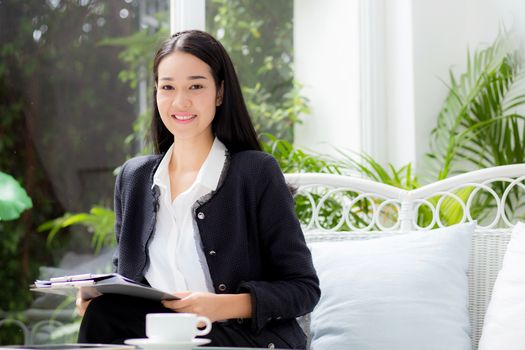 Asian business woman holding clipboard folder in the office.