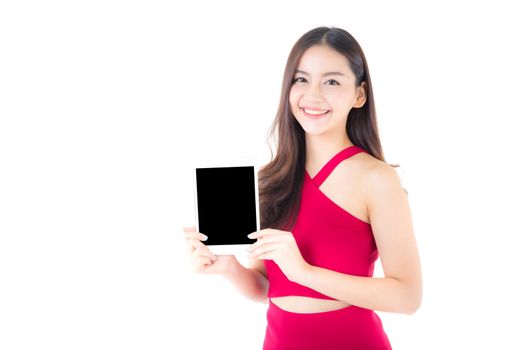 Portrait of asian young woman with red dress standing showing blank screen tablet isolated on white background.